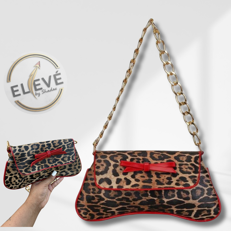 Leopard print handbag with red bow and gold chain strap